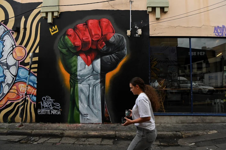 Large mural in Palestinian colours by noted artist Scottie Marsh featured on the laneway wall beside Cairo Takeaway